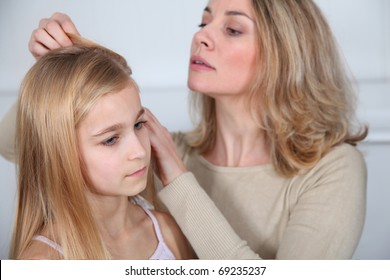 Mother Treating Daughter's Hair Against Lice