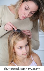 Mother Treating Daughter's Hair Against Lice