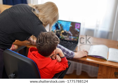 Mother turning off computer for computer addicted little gamer kid, internet and game dependency