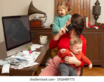 Mother With Two Child At Home. Kids Crying. Childcare And Working Mom. Woman Talk By Phone. Toddler Tantrum. Young Lady Working At Home During Quarantine. Real People. A Lot Of Bills On The Table.