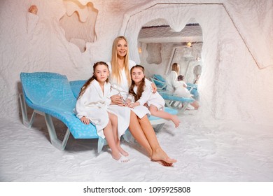 Mother with two children in salt room. Halotherapy for treatment of respiratory diseases.