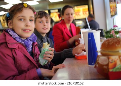 Mother With Two Kids Have A Snack In A Fast Food Restaurant