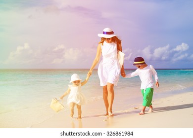 Mother And Two Kids Walking On Tropical Beach, Family Vacation