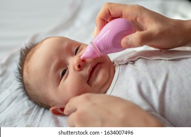 Mother Using Baby Nasal Aspirator Mucus Nose Suction