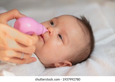 Mother Using Baby Nasal Aspirator Mucus Nose Suction