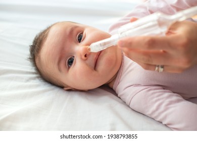 Mother Using Baby Nasal Aspirator Mucus Nose Suction