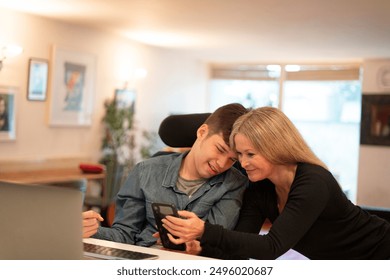 Mother using smartphone with disabled son - Powered by Shutterstock