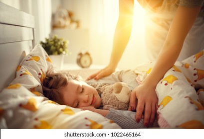 Mother Wakes Up Sleeping Child Daughter Girl In The Morning