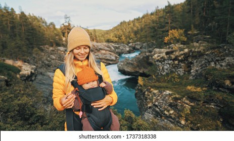 Mother Walking With Baby Carrier In Forest Family Traveling In Norway Vacation  Outdoor Woman With Infant Child Together Healthy Lifestyle Autumn Season 