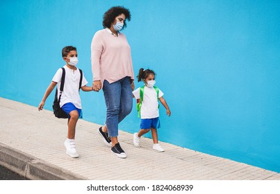 Mother Walking And Holding Hands Of Children While Wearing Surgical Face Mask - Concept Of Back To School With Safey Measures