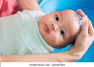 Mother Washing Baby Girl Hair