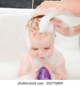  Mother Washing Baby Hair In Bath.
