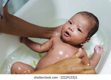 Mother Washing Shower Happy Asian Newborn Baby In Bath. Mom, Kid And Health Care Concept