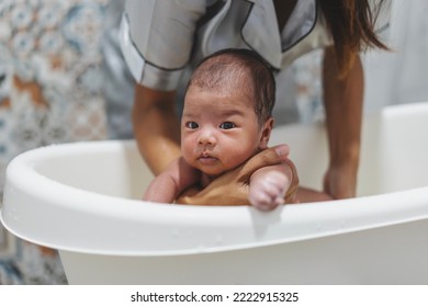 Mother Washing Shower Happy Asian Newborn Baby In Bath. Mom, Kid And Health Care Concept