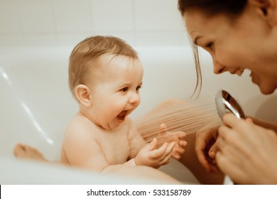 Mother Washing Shower Happy Newborn Baby In Bath