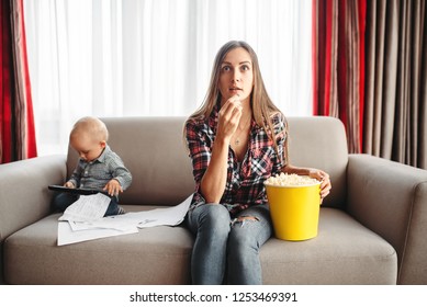 Mother Watch Tv And Eats Popcorn, Little Kid Near