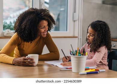 Mother is watching her daughter draw - Shutterstock ID 2254630389