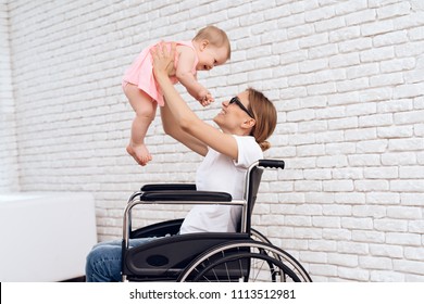 Mother In Wheelchair Play With Newborn Baby. Disabled, Motherhood Concept.