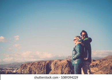 Mother With White Hair And A 45 Year Old Son Spend Time Together Smiling, Surrounded By Unspoiled Nature. Between Sea And Mountain Hiking And Trekking Activity