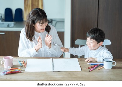 A mother who praises a child playing in the room - Shutterstock ID 2279970623