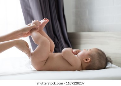 Mother Wipe The Bottom And The Body Baby With Wet Tissues After Bath