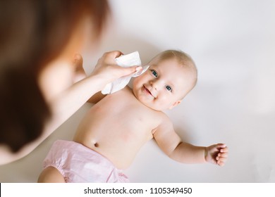 Mother Wiping Baby's Face - Shutterstock ID 1105349450