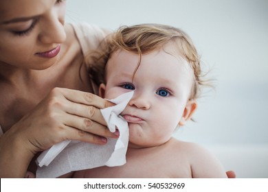 Mother Wiping Baby's Face - Powered by Shutterstock