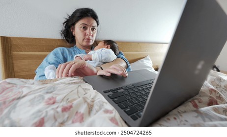 Mother working from bed with newborn baby, showcasing the challenges and balance of remote work and parenting, highlighting the connection and bonding between mother and child in a home setting - Powered by Shutterstock