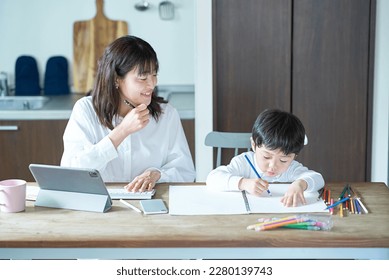 A mother working in her room and a child drawing