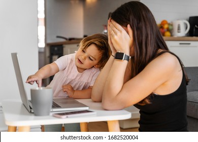 Mother working from home with baby toddler. Crying child and stressed woman. Stay home