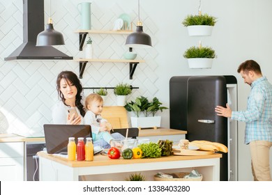 Mother Working From Home, Cooking, Talking Phone, Taking Care Of Her Child. Mommy Bsinesswoman. Hungry Father Searching Food In Empty Fridge Multitasking And Husework Concept.