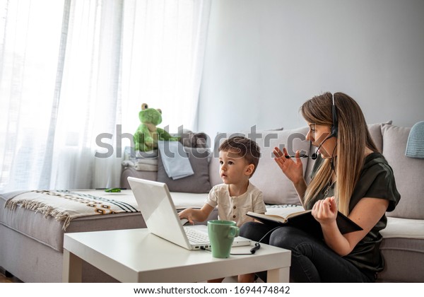 Mother\
working from home with kid. Children make noise and disturb woman\
at work. Homeschooling and freelance job. Moms Can Balance Work and\
Family. Multitasking mother working from home.\

