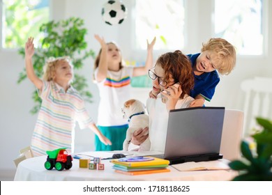 Mother Working From Home With Kids. Homeschooling And Home Office.  Quarantine, Closed School, Coronavirus Outbreak. Self Isolation And Social Distancing. Children Make Noise And Disturb Mom At Work. 