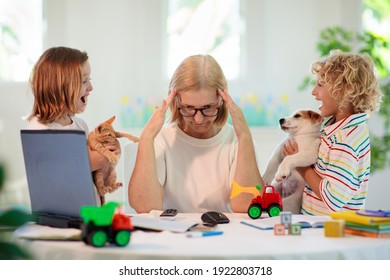 Mother Working From Home With Kids. Homeschooling And Home Office.  Quarantine, Closed School, Coronavirus Outbreak. Self Isolation And Social Distancing. Children Make Noise And Disturb Mom At Work. 