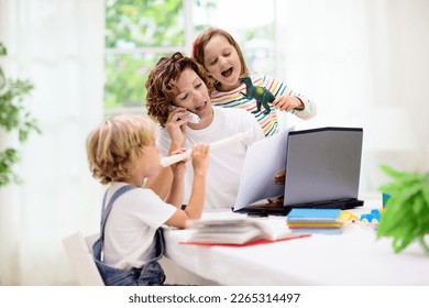 Mother working from home with kids on summer holiday. Children make noise and disturb woman at work. Homeschooling and freelance job. Boy and girl playing making loud noise. - Shutterstock ID 2265314497