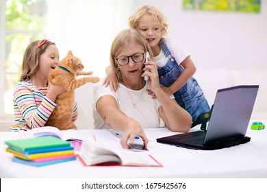 Mother working from home with kids. Quarantine and closed school during coronavirus outbreak. Children make noise and disturb woman at work. Homeschooling and freelance job. Boy and girl playing.