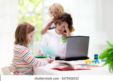 Mother working from home with kids. Quarantine and closed school during coronavirus outbreak. Children make noise and disturb woman at work. Homeschooling and freelance job. Boy and girl playing. - Shutterstock ID 1675426315