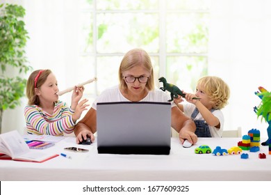 Mother working from home with kids. Quarantine and closed school during coronavirus outbreak. Children make noise and disturb woman at work. Homeschooling and freelance job. Boy and girl playing.