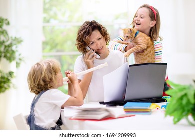 Mother working from home with kids. Quarantine and closed school during coronavirus outbreak. Children make noise and disturb woman at work. Homeschooling and freelance job. Boy and girl playing. - Shutterstock ID 1694209993