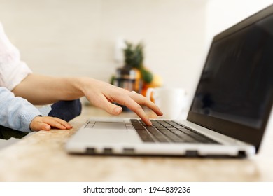 Mother Working On Laptop With Child. Side View Of Woman's And Infant Hands On Notebook. Business Mom And Little Baby Using Laptop Computer In Home. Top View, Flat Lay. Close Up. Female Business.