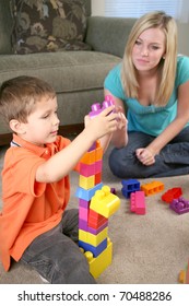 A mother and young son playing with blocks