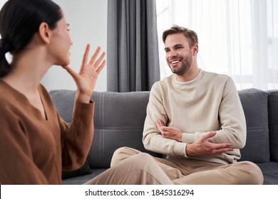 Mother Of Your Child. Smiling Caucasian Man Looking At His Hearing Impairment Woman And Using Sign Language While Telling About Their Future Baby. Hand Gestures Of People With Hearing Impairment