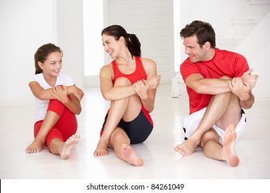 Mother,father and daughter doing yoga - Powered by Shutterstock