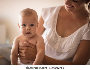 Motherhood Is An Instinct That Comes Naturally To Most. Mother And Her Baby Boy At Home.