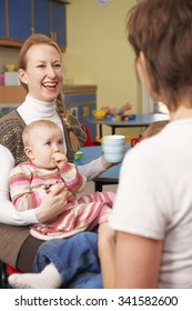 Mothers With Babies Chatting At Playgroup