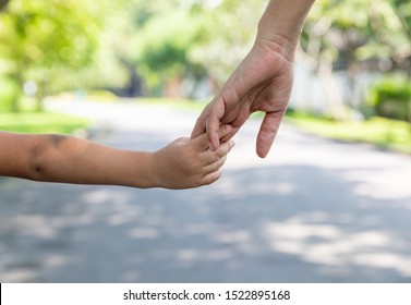 Mother's and child hold hands. Happy in the garden. Mother's love in the hand, on the palm
