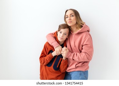 Mothers Day, Children And Family Concept - Teen Boy Hugging His Mom On White Background