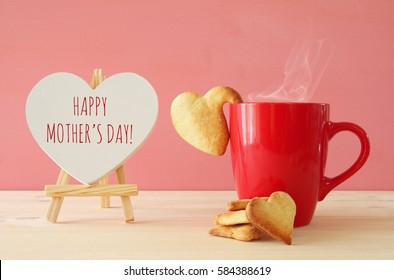 mother's day concept image. Board next to cup of coffee and heart cookies - Powered by Shutterstock