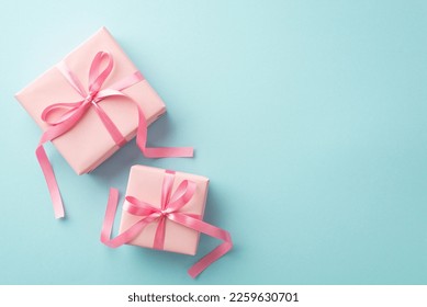 Mother's Day concept. Top view photo of pink present boxes with ribbon bows on isolated pastel blue background with copyspace