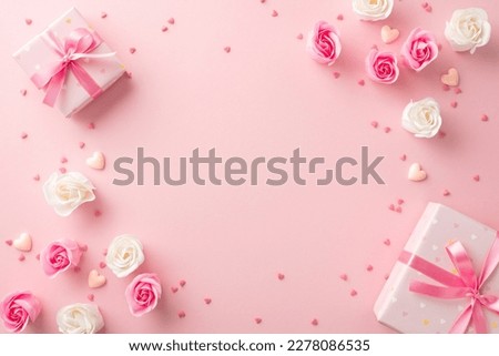 Mother's Day decorations concept. Top view photo of stylish gift boxes with ribbon bows white and pink roses small hearts and sprinkles on isolated pastel pink background with copyspace in the middle
